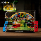 KGBOX clear acrylic display case for LEGO 72050 Mario Kart Luigi Mach 8 - front view of empty case with handheld-console design and red blue controller accents