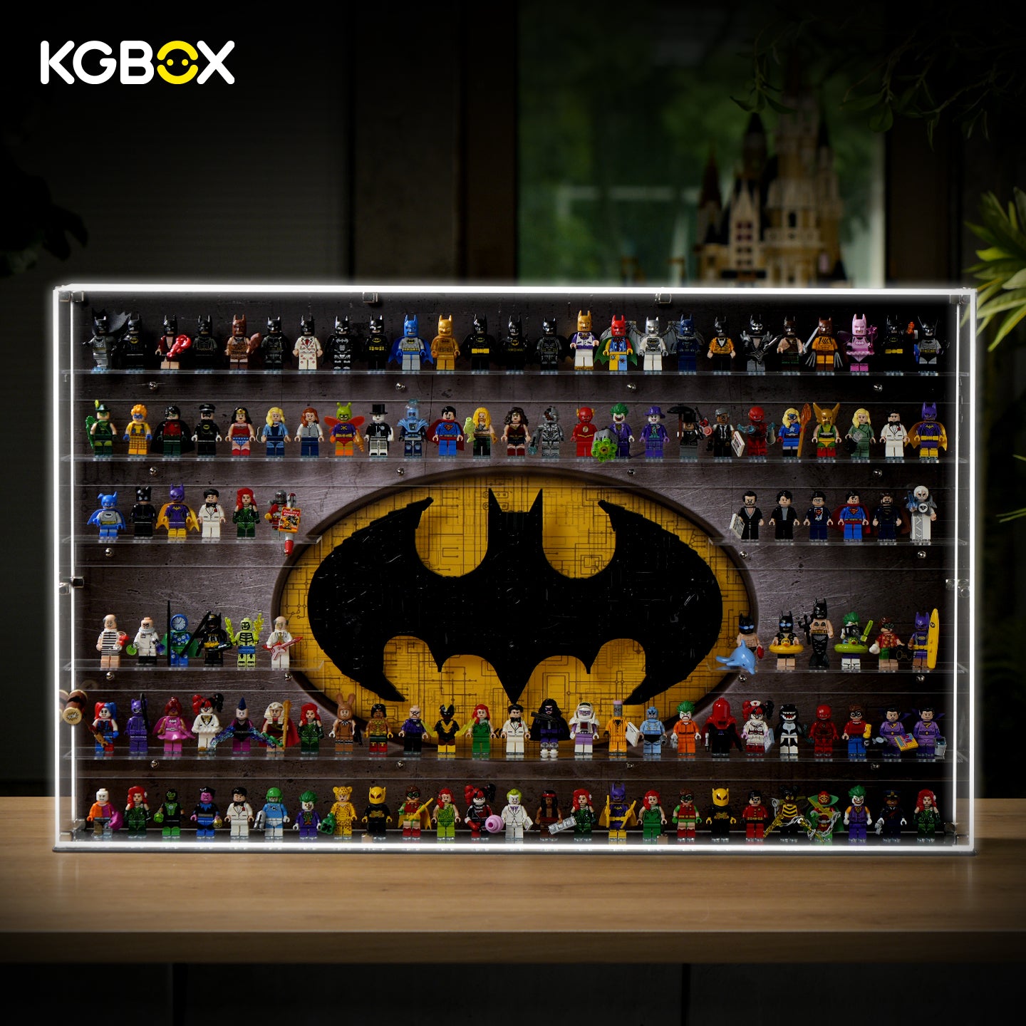 KGBOX LED wall‑mount acrylic display case with upgraded 5mm outer frame, loaded with LEGO 76330 Batman Logo and 124 Batman minifigures, lit front main view
