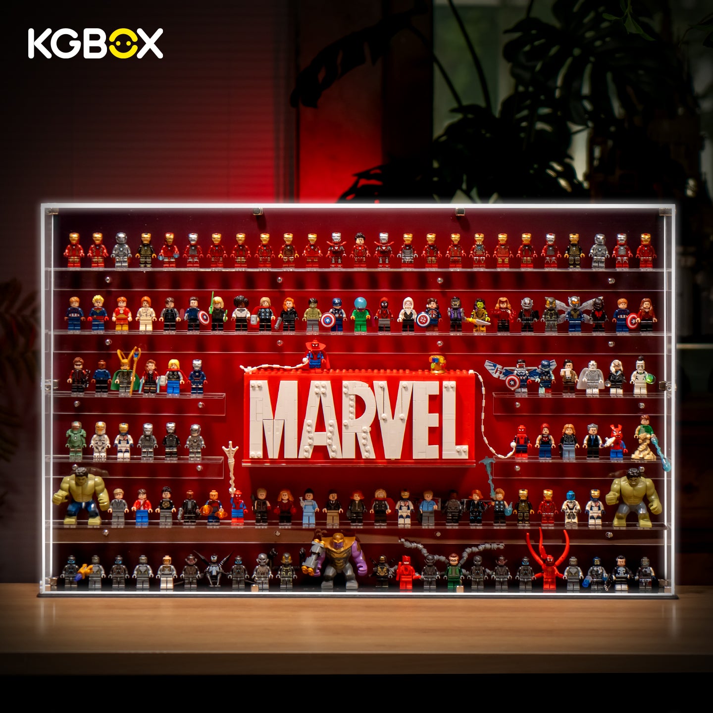 KGBOX LED wall‑mount acrylic display case with upgraded 5mm outer frame, loaded with LEGO 76313 Marvel Logo and 124 Marvel minifigures, lit front main view
